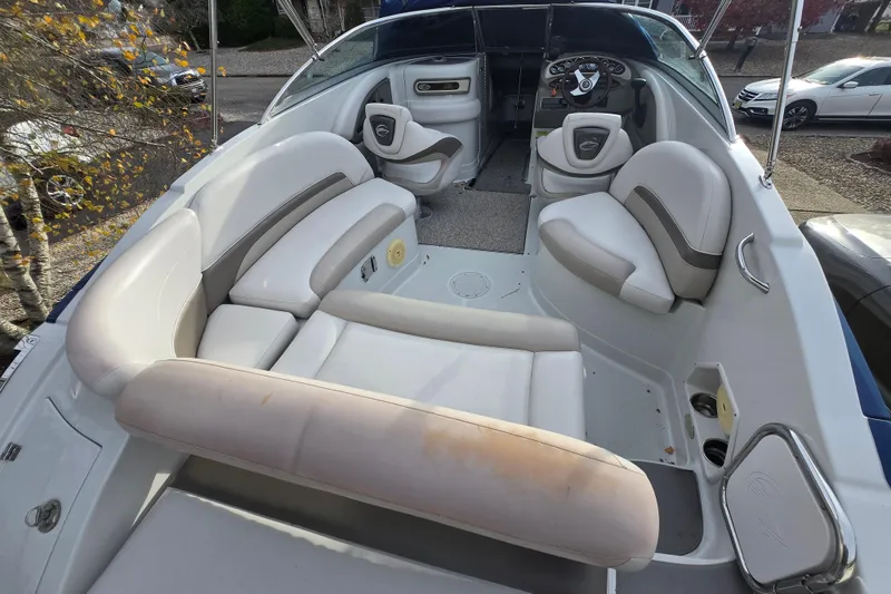 Slide: The Image of 2012 Crownline Eclipse E4 boat interior with white seating and steering console. - 5