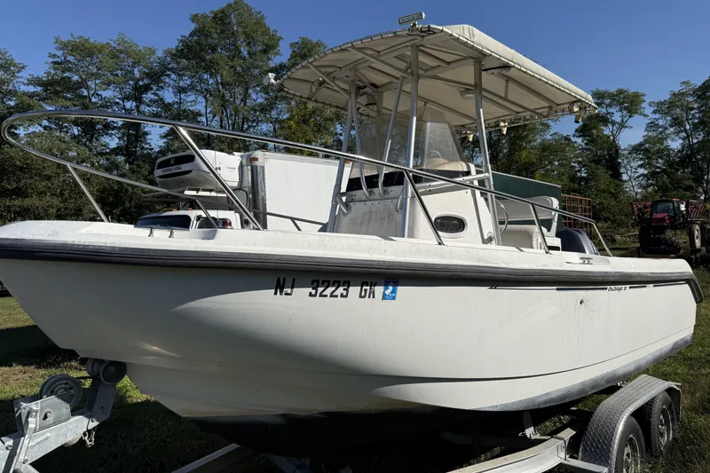 Slide: The Image of 1999 Boston Whaler 21 Outrage boat interior with seating and storage compartments. - 11