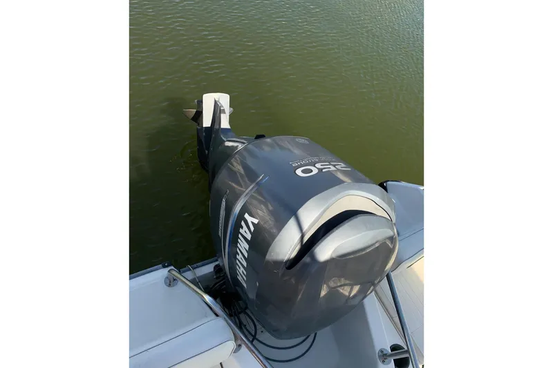 Slide: The Image of 1999 Boston Whaler 21 Outrage boat deck with railing and storage compartment. - 16