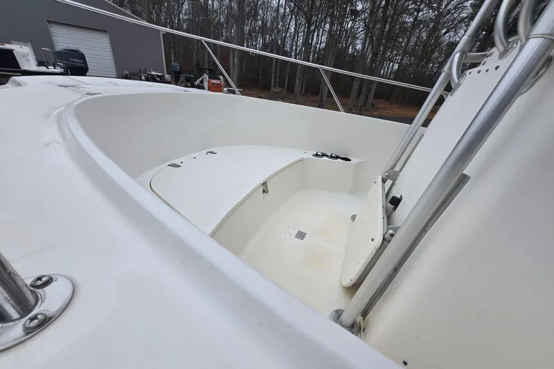 Slide: The Image of 1999 Boston Whaler 21 Outrage boat interior with seating and railing, parked outdoors. - 18