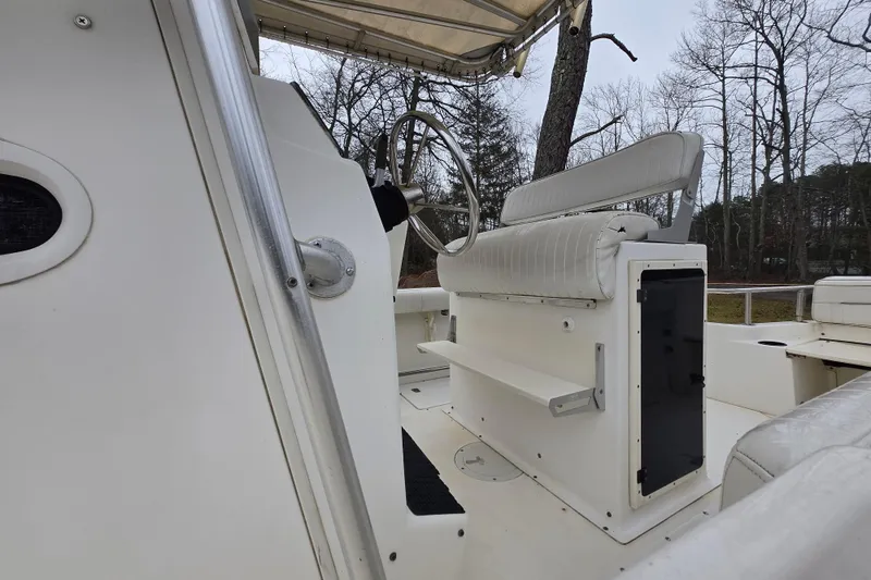 Slide: The Image of 1999 Boston Whaler 21 Outrage boat interior with steering wheel and seating. - 20