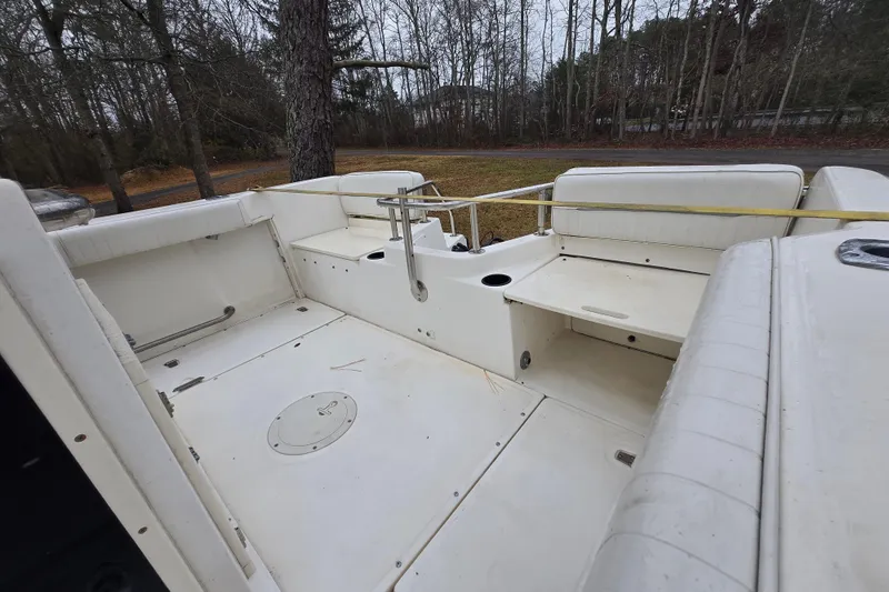 Slide: The Image of 1999 Boston Whaler 21 Outrage boat interior with seating and storage compartments. - 22
