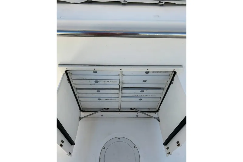 Slide: The Image of Storage compartment on a 1999 Boston Whaler 21 Outrage boat. - 29
