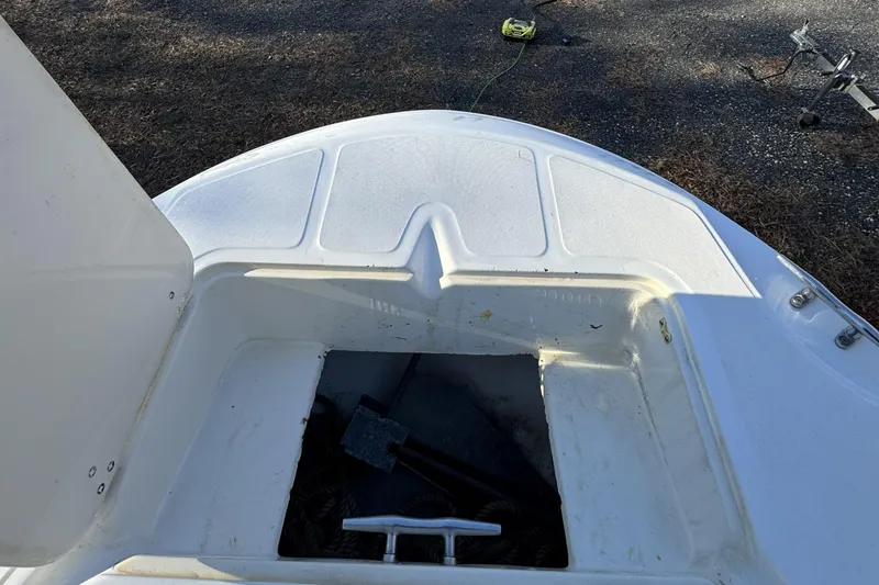 Slide: The Image of 1999 Boston Whaler 21 Outrage boat deck with open storage compartment. - 31