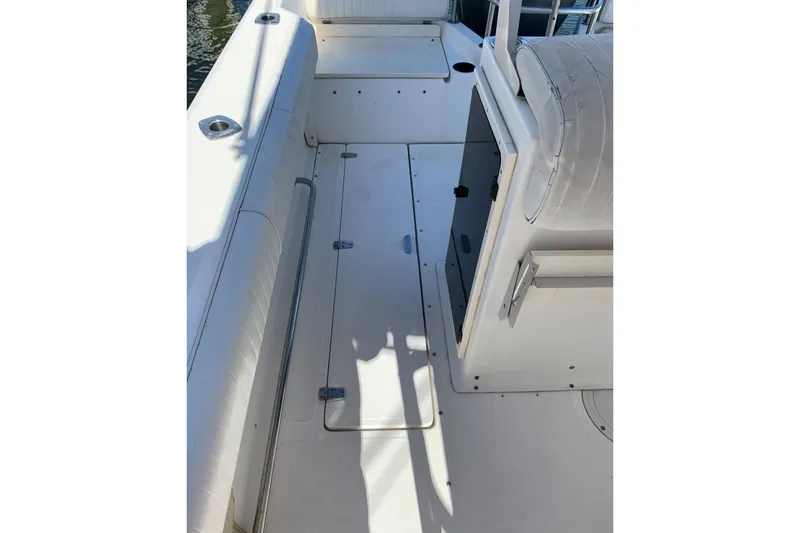 Slide: The Image of 1999 Boston Whaler 21 Outrage boat on trailer, parked outdoors. - 5
