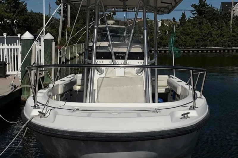 Slide: The Image of 1999 Boston Whaler 21 Outrage boat on trailer, parked outdoors. - 6