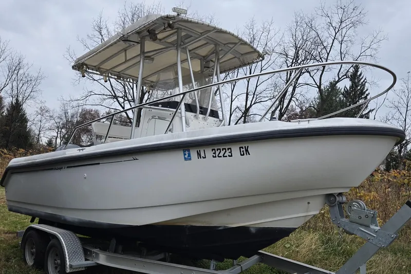 Slide: The Image of 1999 Boston Whaler 21 Outrage boat cockpit with steering wheel and control panel. - 7