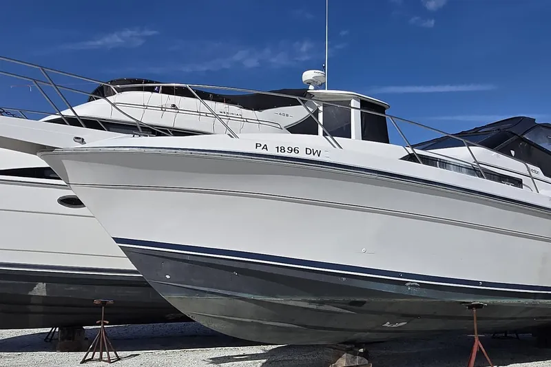 The Image of 1987 Silverton 34X Express boat on stands, clear sky background. - 0