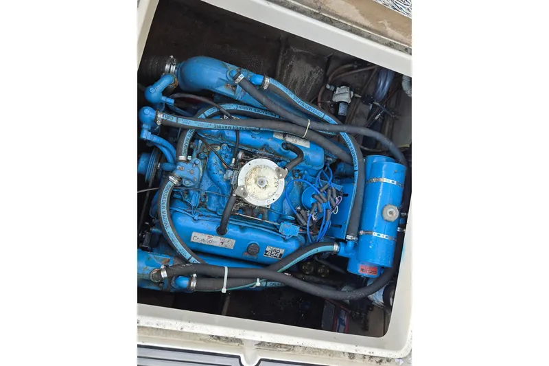 Slide: The Image of 1987 Silverton 34X Express engine compartment with blue marine engine components. - 14