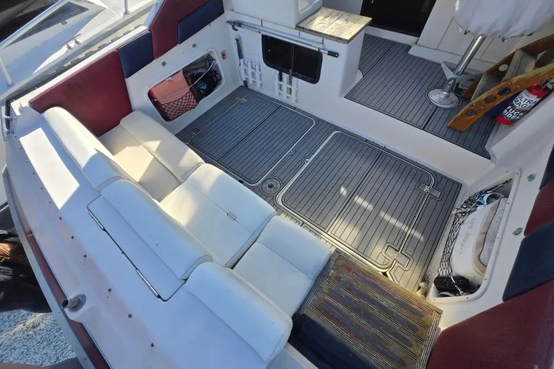 Slide: The Image of 1987 Silverton 34X Express boat interior with white seating and gray flooring. - 5