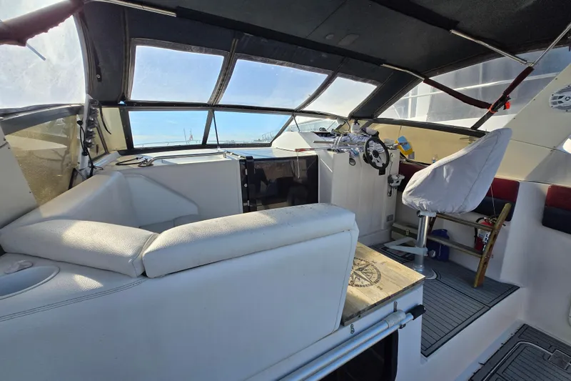 Slide: The Image of 1987 Silverton 34X Express boat interior with helm, seating, and panoramic windows. - 6