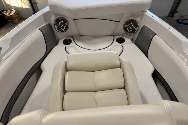 Slide: The Image of 2010 Rinker 296 Captiva Bowrider interior with beige seating and cup holders. - 12