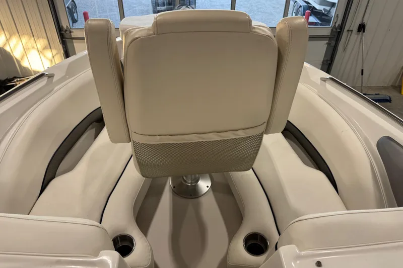 Slide: The Image of 2010 Rinker 296 Captiva Bowrider interior with beige seating and cup holders. - 13