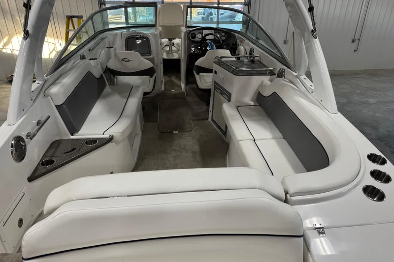 Slide: The Image of 2010 Rinker 296 Captiva Bowrider interior with white seating and sleek design. - 17