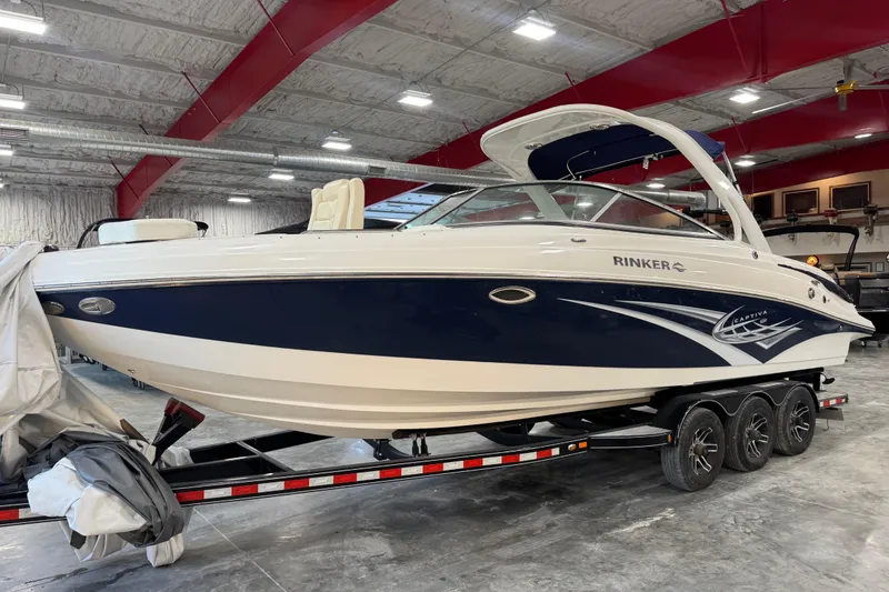Slide: The Image of 2010 Rinker 296 Captiva Bowrider boat on trailer in indoor storage facility. - 3