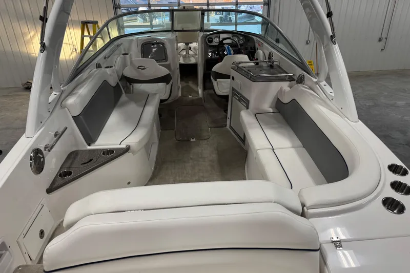 Slide: The Image of 2010 Rinker 296 Captiva Bowrider interior with white seating and modern dashboard. - 6