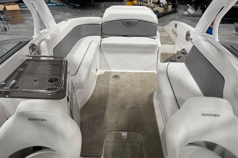 Slide: The Image of 2010 Rinker 296 Captiva Bowrider interior with white seating and gray accents. - 9