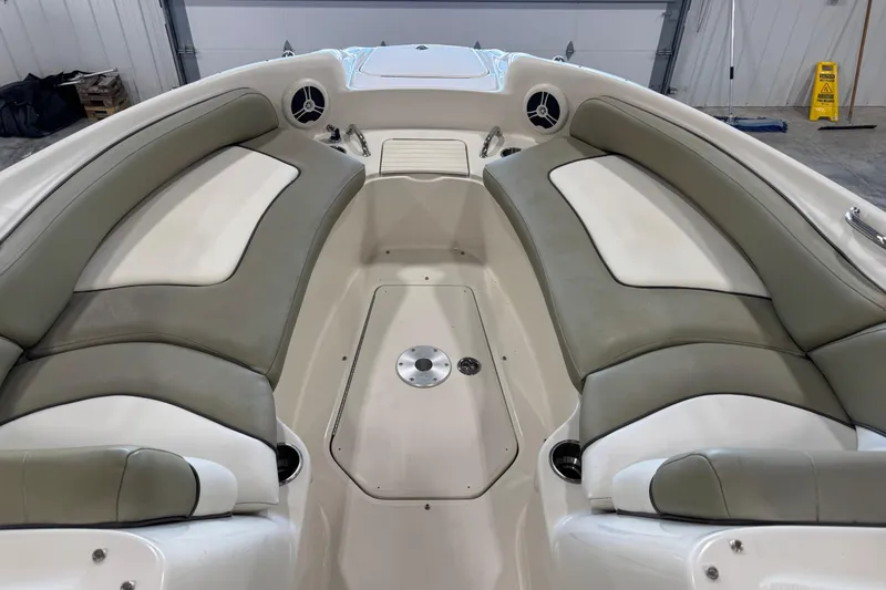 Slide: The Image of 2006 Sea Ray 240 Sundeck interior with cushioned seating and cup holders. - 10