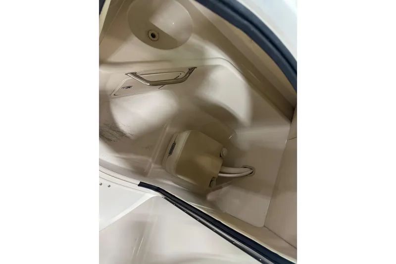 Slide: The Image of 2006 Sea Ray 240 Sundeck interior compartment with storage and sink. - 11