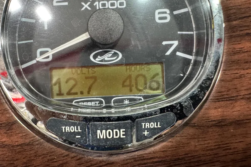 Slide: The Image of Close-up of 2006 Sea Ray 240 Sundeck gauge showing 12.7 volts and 406 hours. - 13