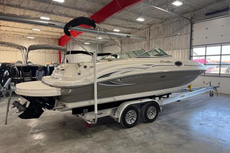 Slide: The Image of 2006 Sea Ray 240 Sundeck boat on trailer in indoor showroom. - 3