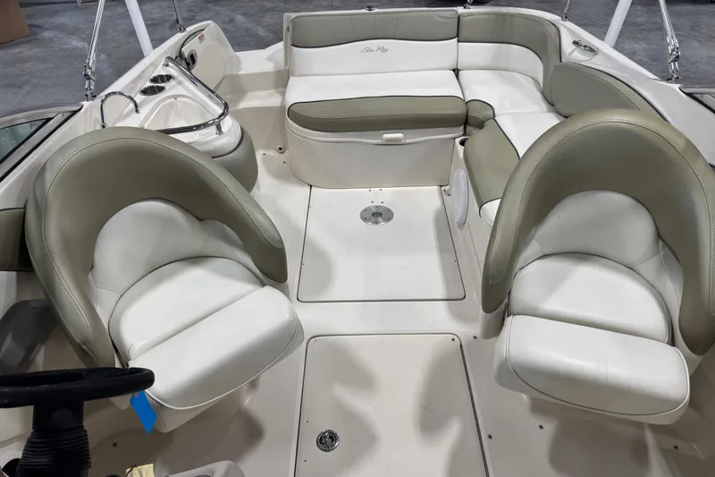 Slide: The Image of 2006 Sea Ray 240 Sundeck interior with white and beige seating arrangement. - 6