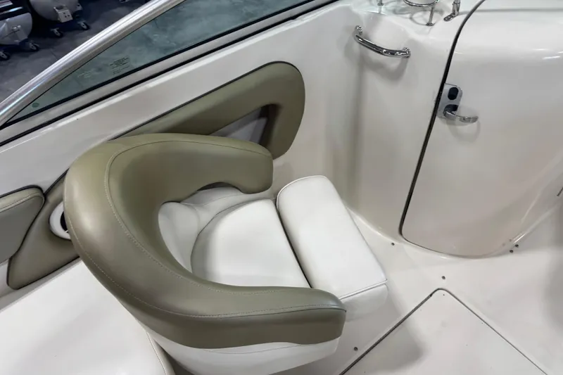 Slide: The Image of 2006 Sea Ray 240 Sundeck interior with beige and white seating. - 8