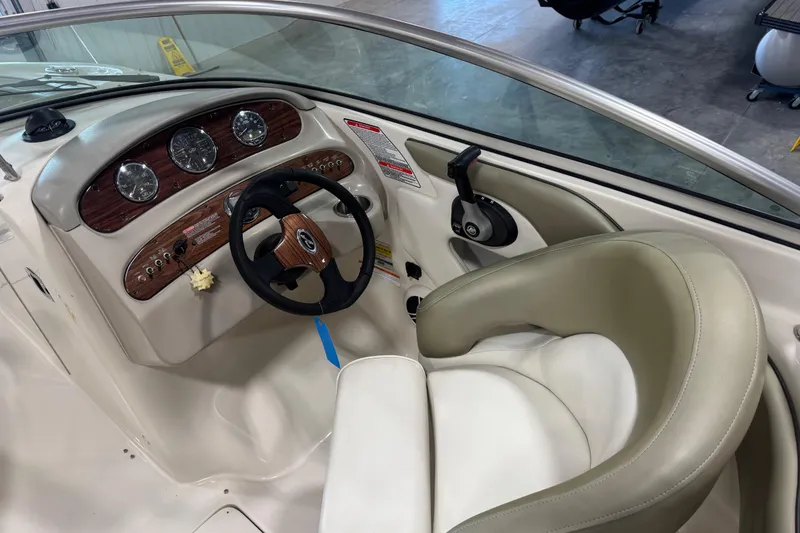 Slide: The Image of Interior view of 2006 Sea Ray 240 Sundeck boat cockpit with steering wheel and gauges. - 9