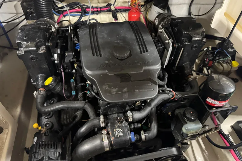 Slide: The Image of Engine compartment of a 2005 Sea Ray 240 Sundeck boat, featuring a MerCruiser engine. - 15