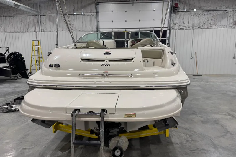 Slide: The Image of 2005 Sea Ray 240 Sundeck boat in a garage, rear view with swim platform. - 6
