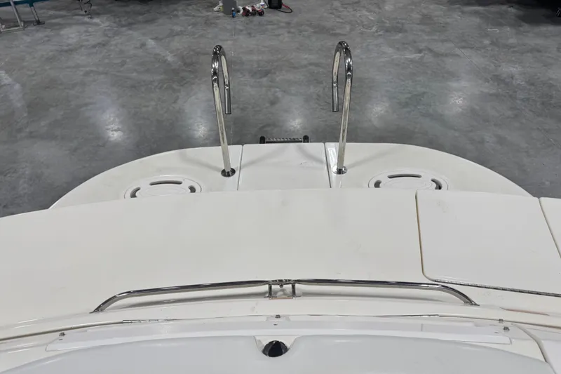 Slide: The Image of 1998 Sea Ray 280 Bow Rider swim platform with stainless steel rails in a showroom. - 10