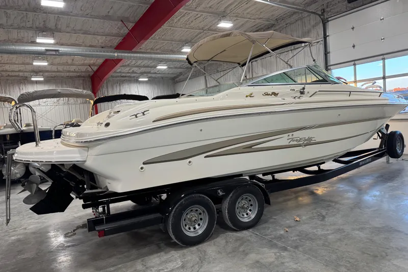 Slide: The Image of 1998 Sea Ray 280 Bow Rider boat on trailer in indoor storage facility. - 3