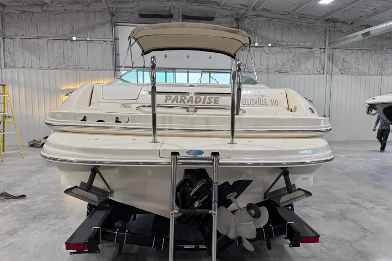 Slide: The Image of 1998 Sea Ray 280 Bow Rider boat in a warehouse, labeled "Paradise," with a visible propeller. - 5