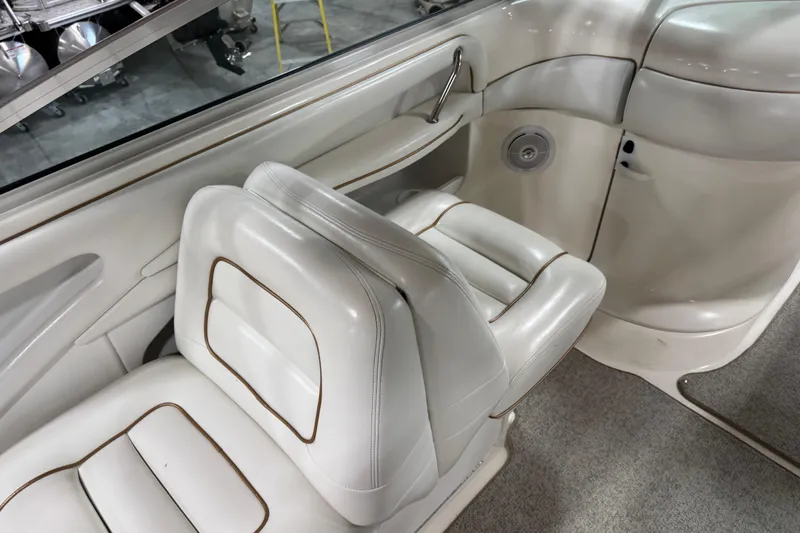 Slide: The Image of 1998 Sea Ray 280 Bow Rider interior with white leather seating and sleek design. - 6