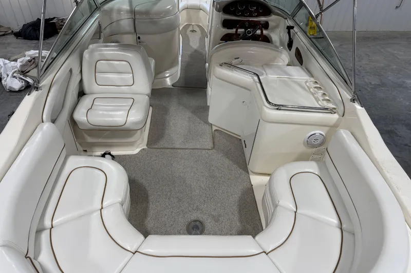 Slide: The Image of 1998 Sea Ray 280 Bow Rider interior with white seating and dashboard. - 7