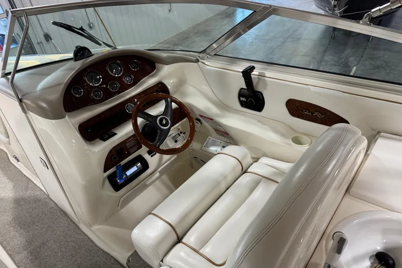 Slide: The Image of 1998 Sea Ray 280 Bow Rider cockpit with steering wheel and instrument panel. - 8
