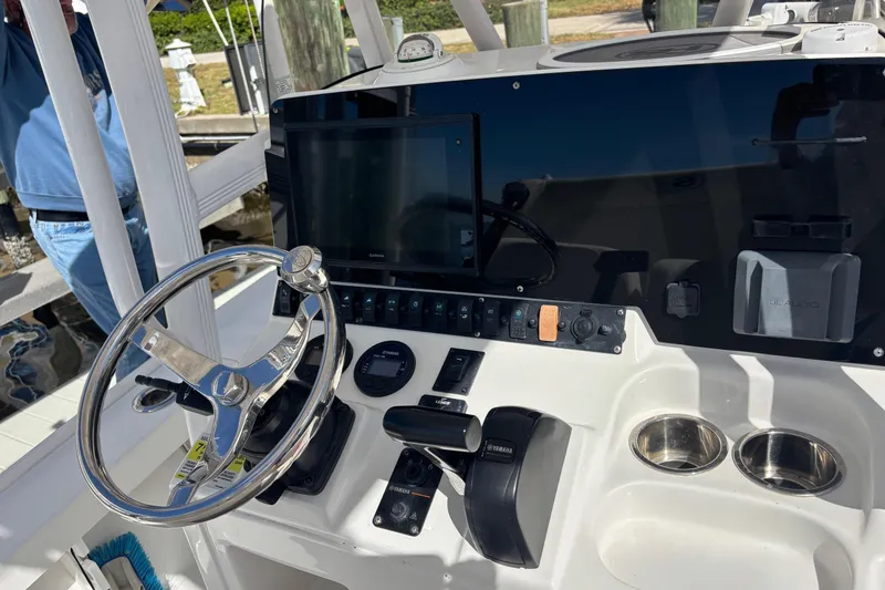 Slide: The Image of 2022 Sea Hunt BX 22 boat dashboard with steering wheel and navigation controls. - 13