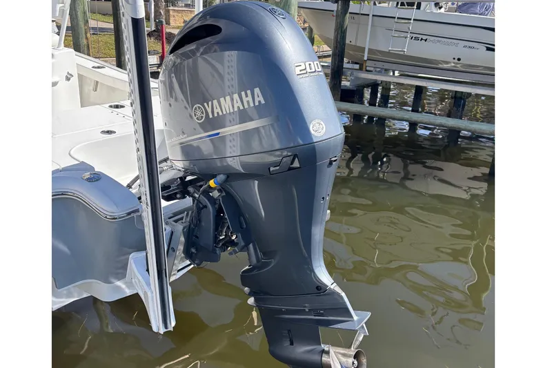 Slide: The Image of 2022 Sea Hunt BX 22 Pro with Yamaha 200 outboard motor docked by water. - 6
