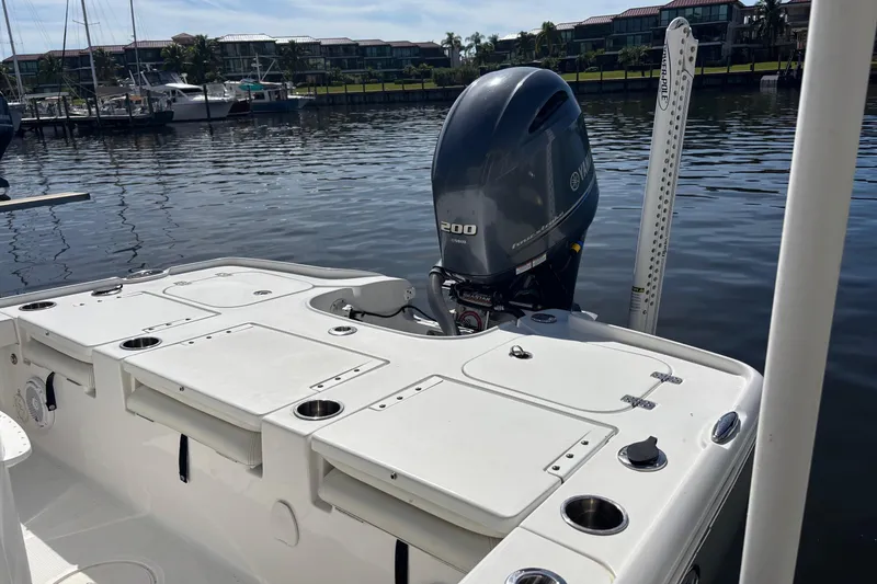 Slide: The Image of 2022 Sea Hunt BX 22 Pro boat with Yamaha 200 engine docked by waterfront. - 7