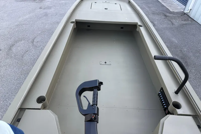 Slide: The Image of 2025 Diamondback 1860 Mudd Rattler boat interior, featuring spacious deck and control handle. - 6