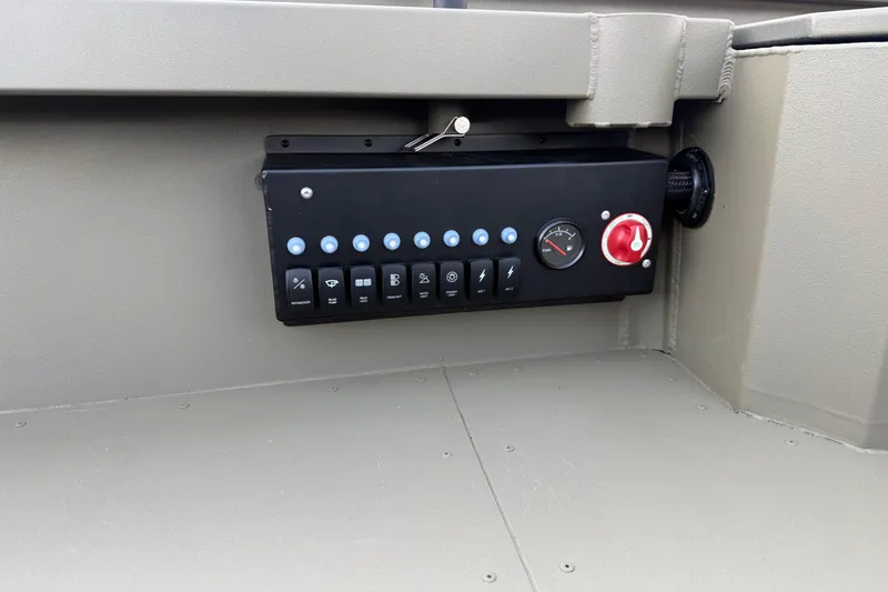 Slide: The Image of Control panel of 2025 Diamondback 1860 Mudd Rattler boat with switches and gauge. - 7