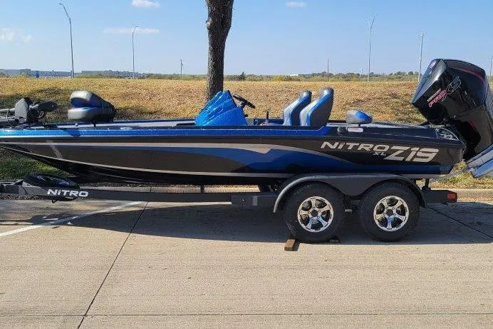 The Image of 2026 Nitro Z19 XL Pro boat on trailer, parked on roadside. - 0