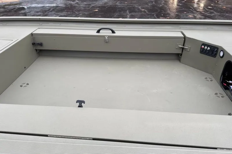 Slide: The Image of 2026 Tracker Grizzly 1654 T Sportsman boat interior with storage and control panel. - 44