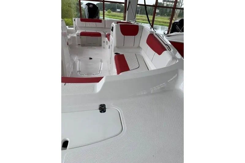 Slide: The Image of 2026 Tahoe 1950 boat interior with red and white seating, docked near water. - 4