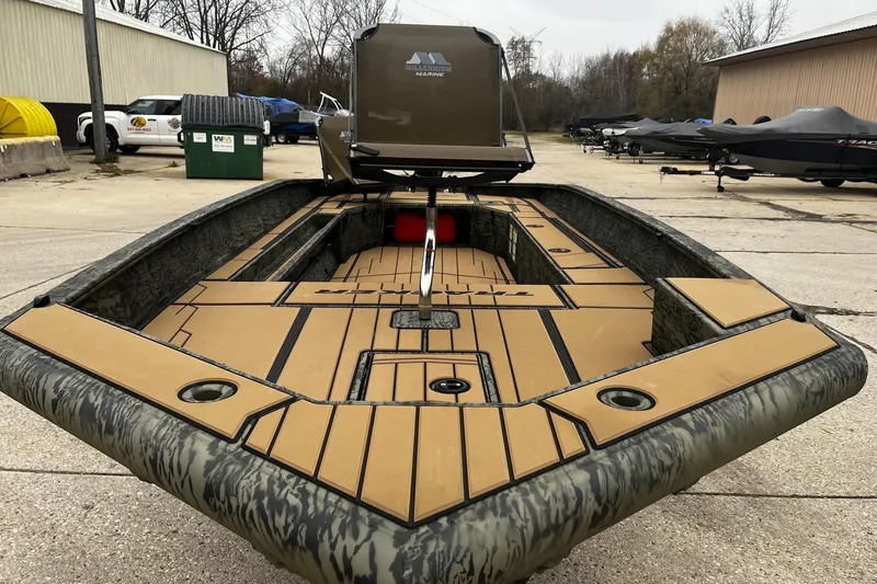 The Image of 2026 Tracker Grizzly 1756 T Marsh boat with camo design, docked outdoors. - 0