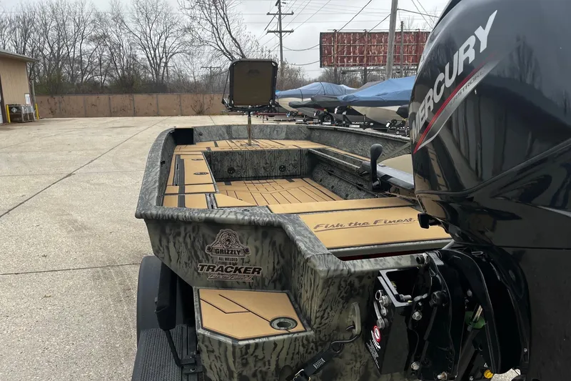 Slide: The Image of 2026 Tracker Grizzly 1756 T Marsh boat with Mercury engine, parked outdoors. - 51