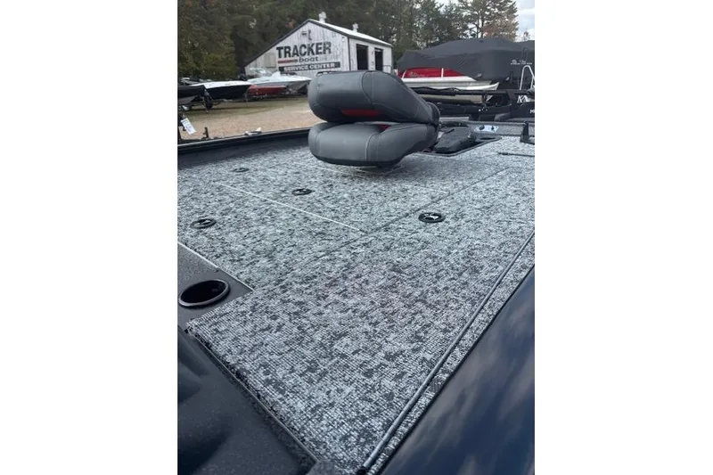 Slide: The Image of 2026 Tracker Pro Team 195 boat deck with seating, at a service center. - 10