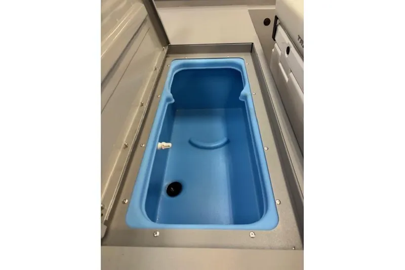 Slide: The Image of 2026 Tracker Bass Tracker Classic CC boat's blue livewell interior. - 8