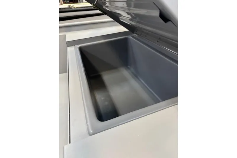 Slide: The Image of Open storage compartment in 2026 Tracker Bass Tracker Classic CC boat. - 9