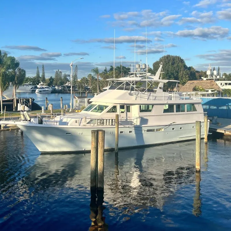 The Image of 1989 Hatteras 65 Motor Yacht docked in a sunny marina setting. - 0
